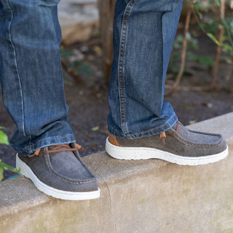 A man wearing jeans and the Justin Hazer in grey.